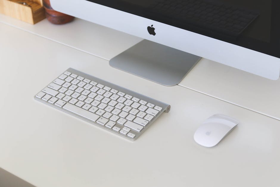 Clean and organized office desk with a computer, keyboard, and mouse in a workplace setting